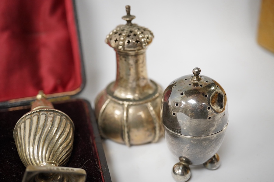 A cased pair of silver pepper pots, Birmingham, 1886, 91mm and five other assorted silver cruets. Condition - poor to fair
